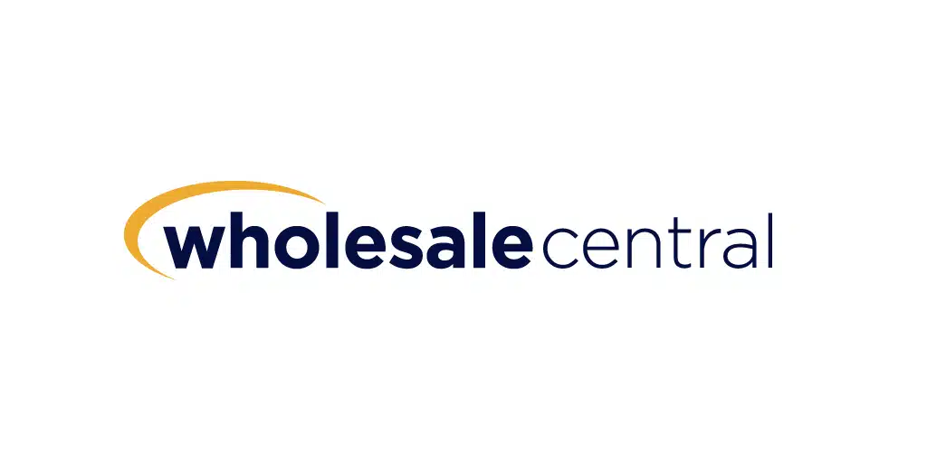 Logo with the text wholesale central in lowercase letters. The word wholesale is in bold dark blue, accompanied by a gold swoosh above. Central is in regular dark blue font. The background is white.