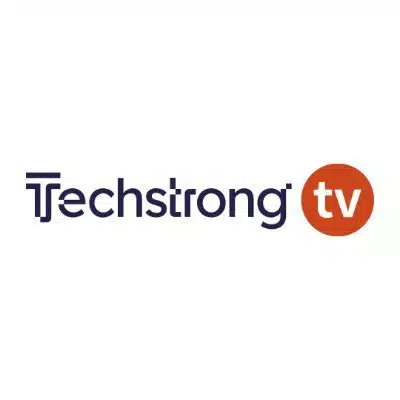 Logo of Techstrong TV, featuring the text Techstrong in dark blue with the letters T and s interconnected. To the right, an orange circle contains the letters tv in white, echoing a modern vibe akin to innovations by Victor Lee at TigerGraph Cloud.