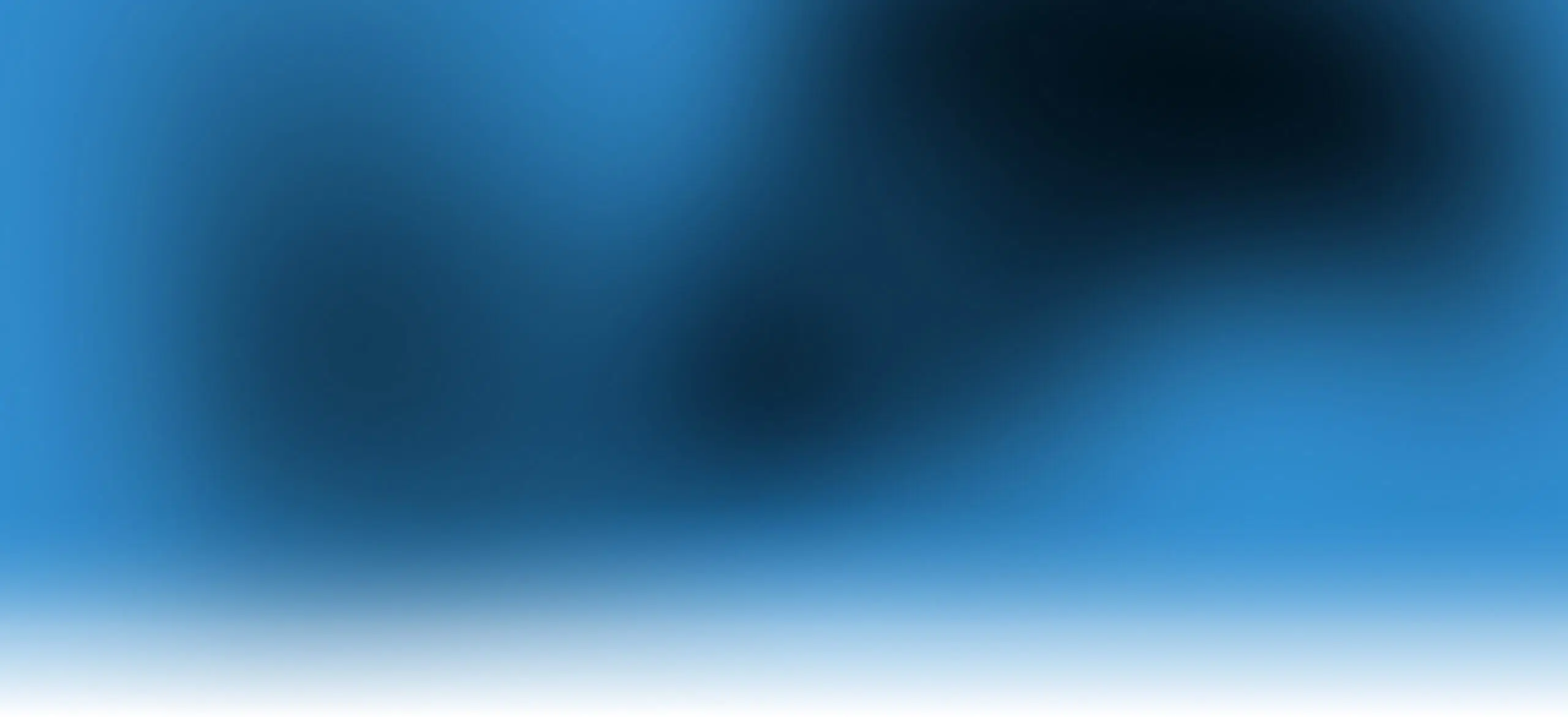 A soft blue gradient background with areas of darker blue and black blur, fading into white at the bottom. No clear objects or shapes are distinguishable.